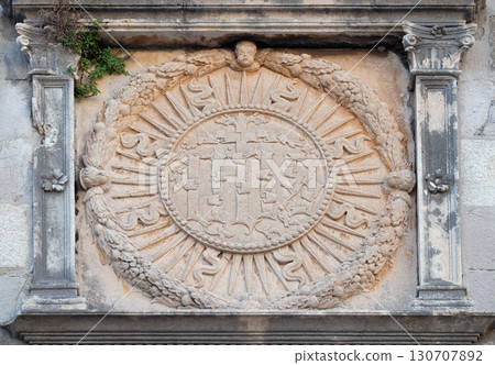 IHS sign on church facade in Dubrovnik, Croatia 130707892