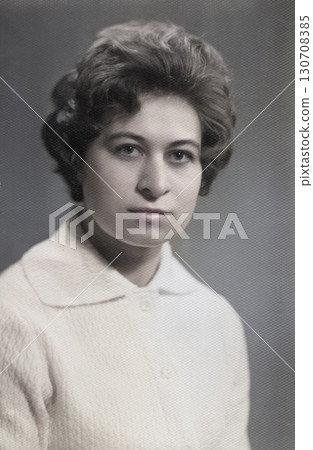 Vintage portrait of a young beautiful woman with a fashionable hairstyle in the 1960s. Retro photo 1965. 130708385