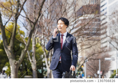 Businessman walking in the office town 130708816