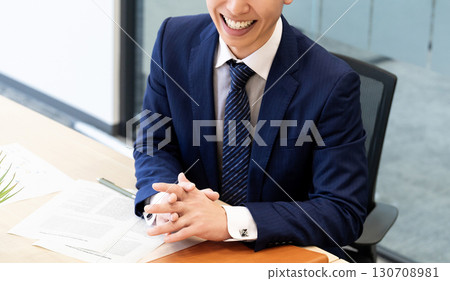Smiling male businessman having a conversation 130708981