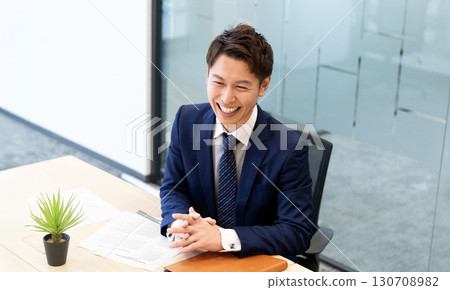 Smiling male businessman having a conversation 130708982