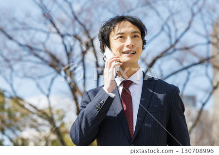 Businessman talking on smartphone 130708996