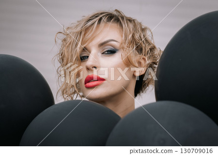 Portrait beautiful woman of model appearance with dark balloons. Art shooting from unusual angles. High quality photo Portrait beautiful woman of model appearance with dark balloons. Art shooting from unusual angles. High quality photo 130709016