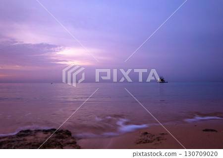 Aerial view to calm sea, sandy beach with rocky coastline. Beautiful sunrise of sun above horizont in summer morning, Sharm El Sheikh, Egypt. Vacation, holiday concept. High quality photo 130709020