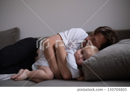 dad and little toddler girl sleeping together on sofa dad and little toddler girl sleeping together on sofa 130709805