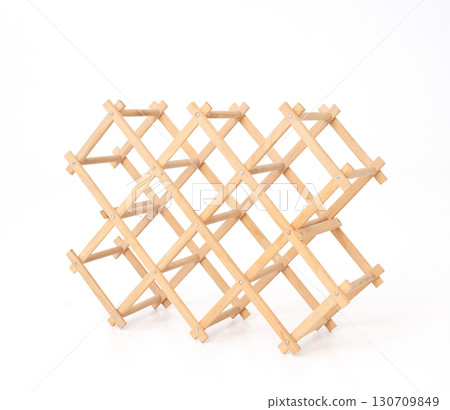 Collapsible wooden wine rack, empty and neatly folded, against a pure white background. wine storage Collapsible wooden wine rack, empty and neatly folded, against a pure white background. wine storage 130709849