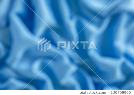Abstract close-up of blue textile folds with soft lighting 130709900