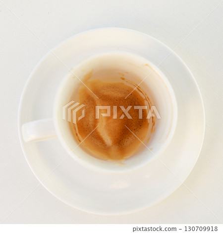 Top view of an empty espresso cup with foam on a white table 130709918