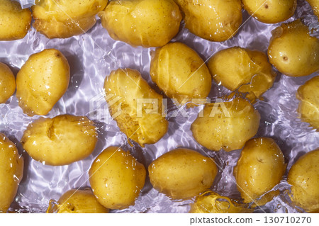 Fresh Organic Potatoes Immersed In Water With Splashing Effect. 130710270