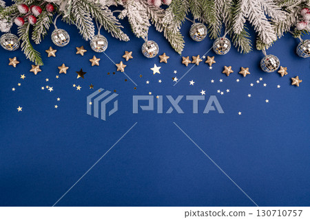 Christmas Lights and Stars with Snowy Pine on Blue Background Christmas Lights and Stars with Snowy Pine on Blue Background 130710757