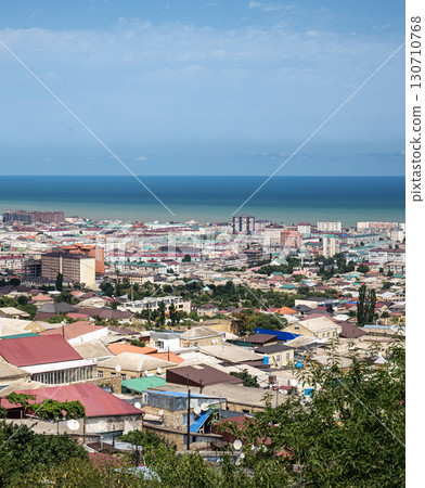 Coastal city with mix of colorful roofs and mid-rise buildings, natural daylight 130710768