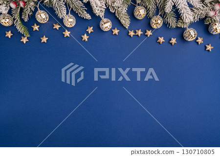 Christmas Lights and Stars with Snowy Pine on Blue Background 130710805