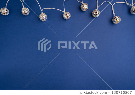 Silver Disco Ball String Lights on Blue Background 130710807