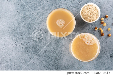 Sattu sharbat is an Indian drink made from roasted black chickpea flour, sugar and water on a blue background 130710813