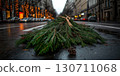 Wet street scene with pine branches on rainy day in festive city setting 130711068