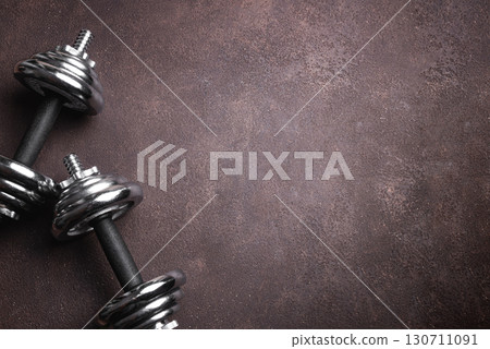 Dumbbells on dark background 130711091