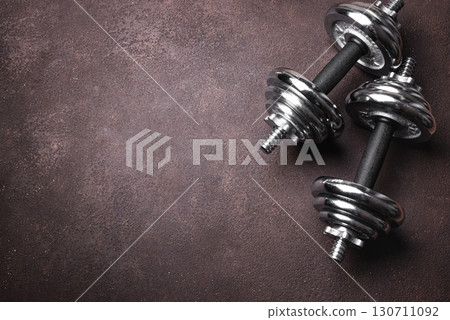 Dumbbells on dark background 130711092