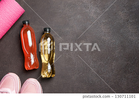 Isotonic sport drink with sneakers and fitness mat 130711101