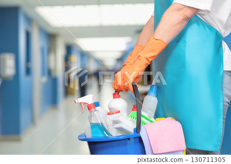 Cleaning staff prepares for work in a busy corridor. 130711305