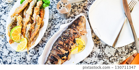 Rainbow trout, grilled, with lemon, and crispy fried lamb, mobile photo, no people, 130711347
