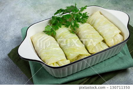 raw cabbage rolls, not cooked, with minced meat, top view, without people, in the spotlight. 130711350
