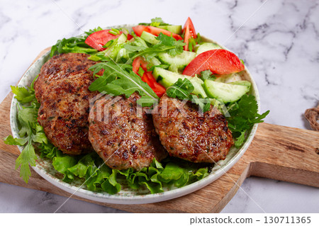 Fried cutlets, mixed minced meat, with vegetable salad, homemade, top view, no people, 130711365