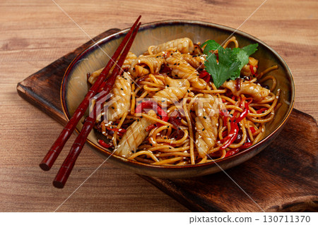 udon noodles, with squid and vegetables, on a wooden table, homemade, no people, 130711370