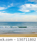 Bright morning landscape of blue sky with fluffy clouds and ocean coast. 130711802