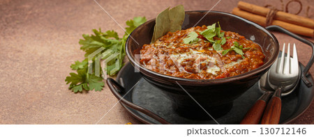 Dal makhani with cream and coriander in bowl is served with spices, traditional dish of India, space for text Dal makhani with cream and coriander in bowl is served with spices, traditional dish of India, space for text 130712146
