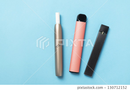 of three different types of vaping devices - a IQOS, a disposable vape, and a pod system on a vibrant blue background. 130712152