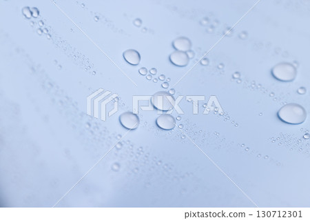 a smooth surface of light blue color covered with water , close up, a beautiful wet blue film in a large number of water drops a smooth surface of light blue color covered with water , close up, a beautiful wet blue film in a large number of water drops 130712301