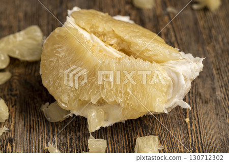 peeled pieces of delicious and sweet citrus fruit while preparing it for eating peeled pieces of delicious and sweet citrus fruit while preparing it for eating 130712302