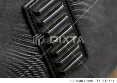 black rubber feet on the bag made of black thick material, details of the black bag with rubber feet for convenience and safety of carrying 130712374