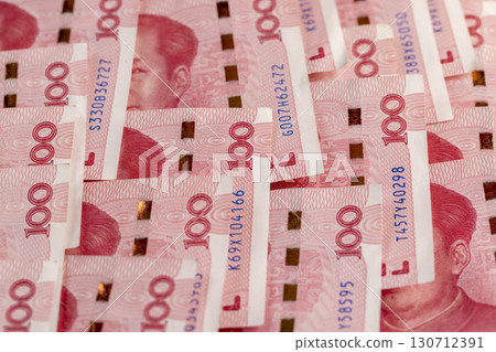the number 100 on a group of red Chinese yuan folded together, the face value of Chinese money folded together, a large amount of money is the Chinese national currency the number 100 on a group of red Chinese yuan folded together, the face value of Chinese money folded together, a large amount of money is the Chinese national currency 130712391