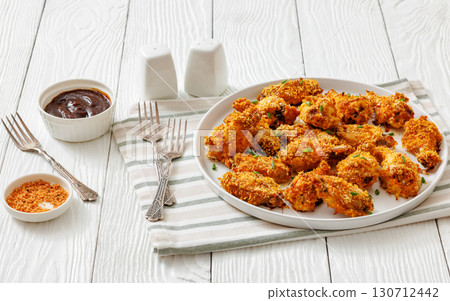 Panko breaded oven baked chicken wings on plate 130712442