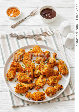 Panko breaded oven baked chicken wings on plate 130712446