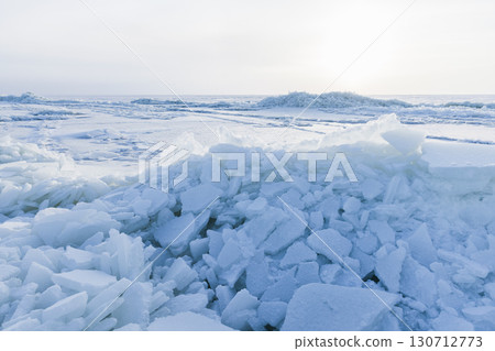 A serene and cold winter landscape featuring layers of ice A serene and cold winter landscape featuring layers of ice 130712773