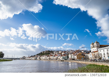 Alcacer do Sal, Portugal view from across the Sado River with Santiago Church on the right and Castle on the left Alcacer do Sal, Portugal view from across the Sado River with Santiago Church on the right and Castle on the left 130712810