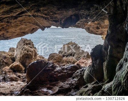 Dark interior of Lapa de Santa Margarida in Arrabida, Setubal, Portugal. Cave with small chapel of spontaneous worship Dark interior of Lapa de Santa Margarida in Arrabida, Setubal, Portugal. Cave with small chapel of spontaneous worship 130712826