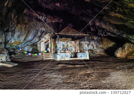 Dark interior of Lapa de Santa Margarida in Arrabida, Setubal, Portugal. Cave with small chapel of spontaneous worship 130712827