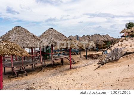 Colorful waters and natural-framed kiosks at Pesqueiro Beach, Soure in Marajo Island, Brazil Colorful waters and natural-framed kiosks at Pesqueiro Beach, Soure in Marajo Island, Brazil 130712901