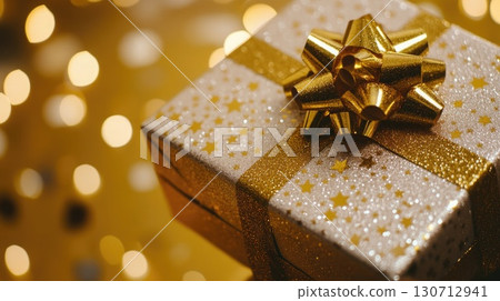 A beautifully wrapped gift box sits against a sparkling background filled with festive colors, highlighting the joy and excitement of welcoming the New Year. A beautifully wrapped gift box sits against a sparkling background filled with festive colors, highlighting the joy and excitement of welcoming the New Year. 130712941