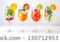 Colorful cocktails made with blended fruits and vegetables are beautifully arranged, each showcasing fresh ingredients like berries, citrus, and herbs. Perfect for a summer celebration. 130712953