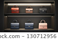 Several leather handbags in different colors and sizes are arranged on shelves under soft lighting, creating an elegant display for shoppers seeking fashion accessories. 130712956