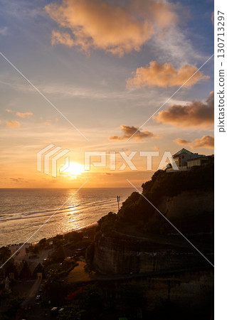 The view of the mountain and the ocean at sunset. A sunny path over the sea. The view of the mountain and the ocean at sunset. A sunny path over the sea. 130713297
