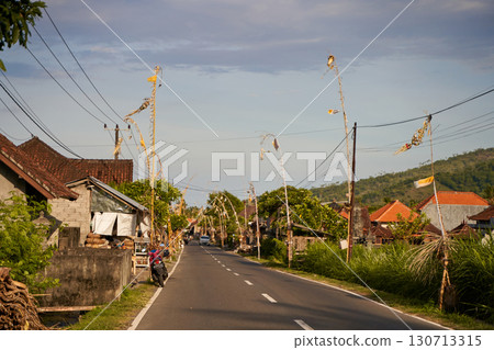 The road decorated for the holiday in the village. Bamboo decorations along the road. 130713315