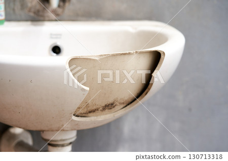 An old dirty broken ceramic sink in the cafeteria outside. 130713318
