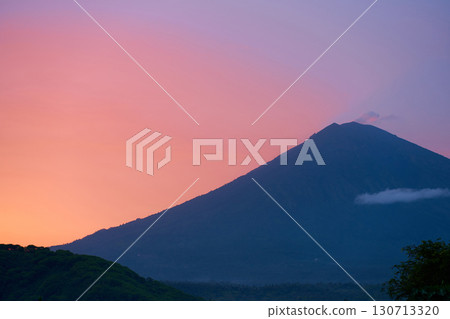 Silhouette of the Agung volcano at sunset. Panorama of the mountain on the island of Bali. 130713320