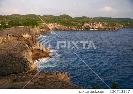 Cinematic aerial landscape shots of the beautiful island of Nusa Penida. Huge cliffs by the shoreline and hidden dream beaches with clear water and foaming wave. Cinematic aerial landscape shots of the beautiful island of Nusa Penida. Huge cliffs by the shoreline and hidden dream beaches with clear water and foaming wave. 130713337