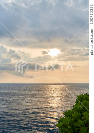 The view of the mountain and the ocean at sunset. A sunny path over the sea. The view of the mountain and the ocean at sunset. A sunny path over the sea. 130713338